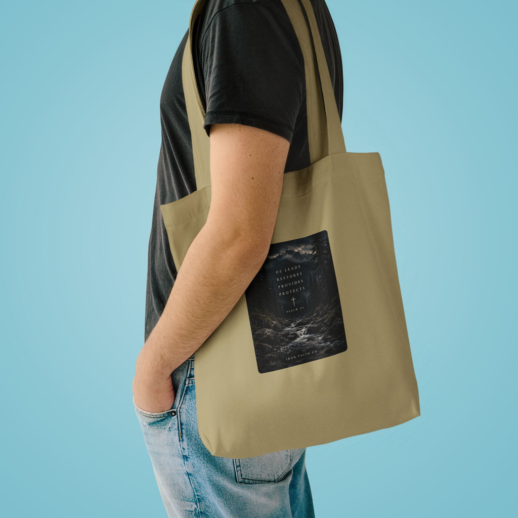 The He Leads Psalm 23 Tote Bag shown in a styled everyday scene (product mockup)