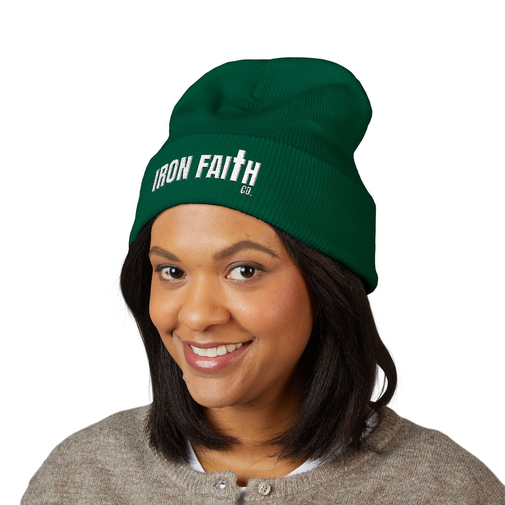 Iron Faith Co. Wordmark Embroidered Cuffed Beanie in green worn by a smiling woman – product mockup
