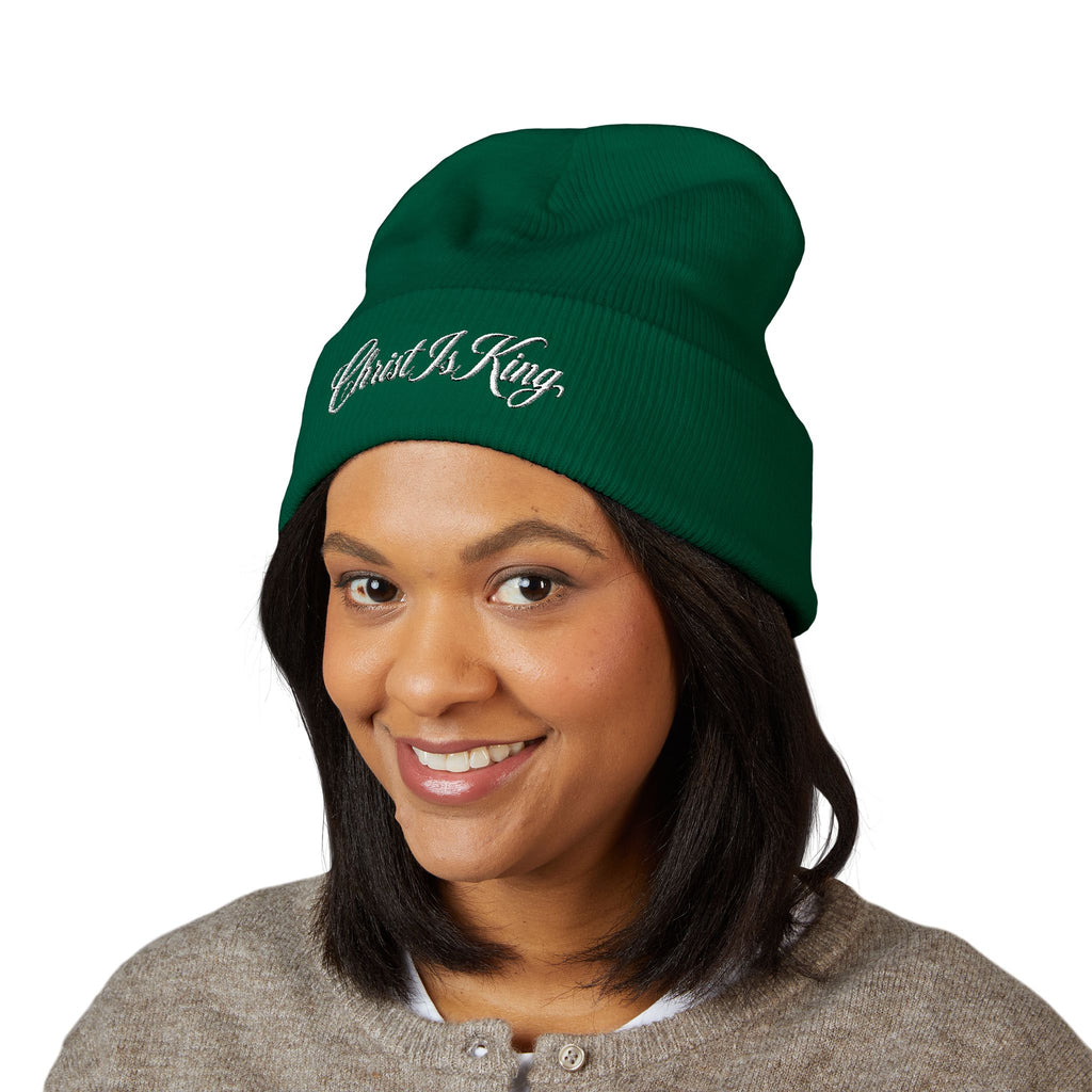 Christ Is King Embroidered Cuffed Beanie in green worn by a smiling woman – product mockup