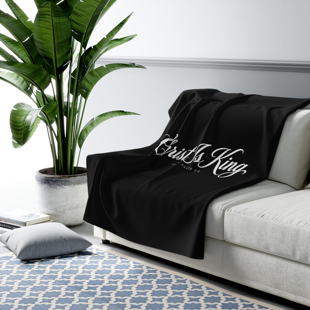 Christ Is King Sherpa Fleece Blanket draped over a gray sofa in a living room – product mockup