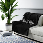Christ Is King Sherpa Fleece Blanket draped over a gray sofa in a living room – product mockup