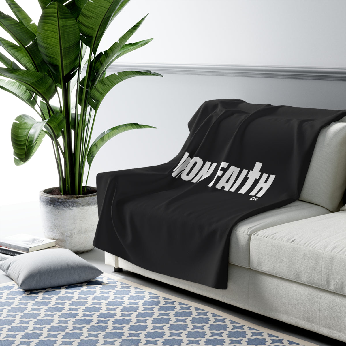 Iron Faith Co. Wordmark Sherpa Fleece Blanket draped over a gray sofa in a living room – product mockup