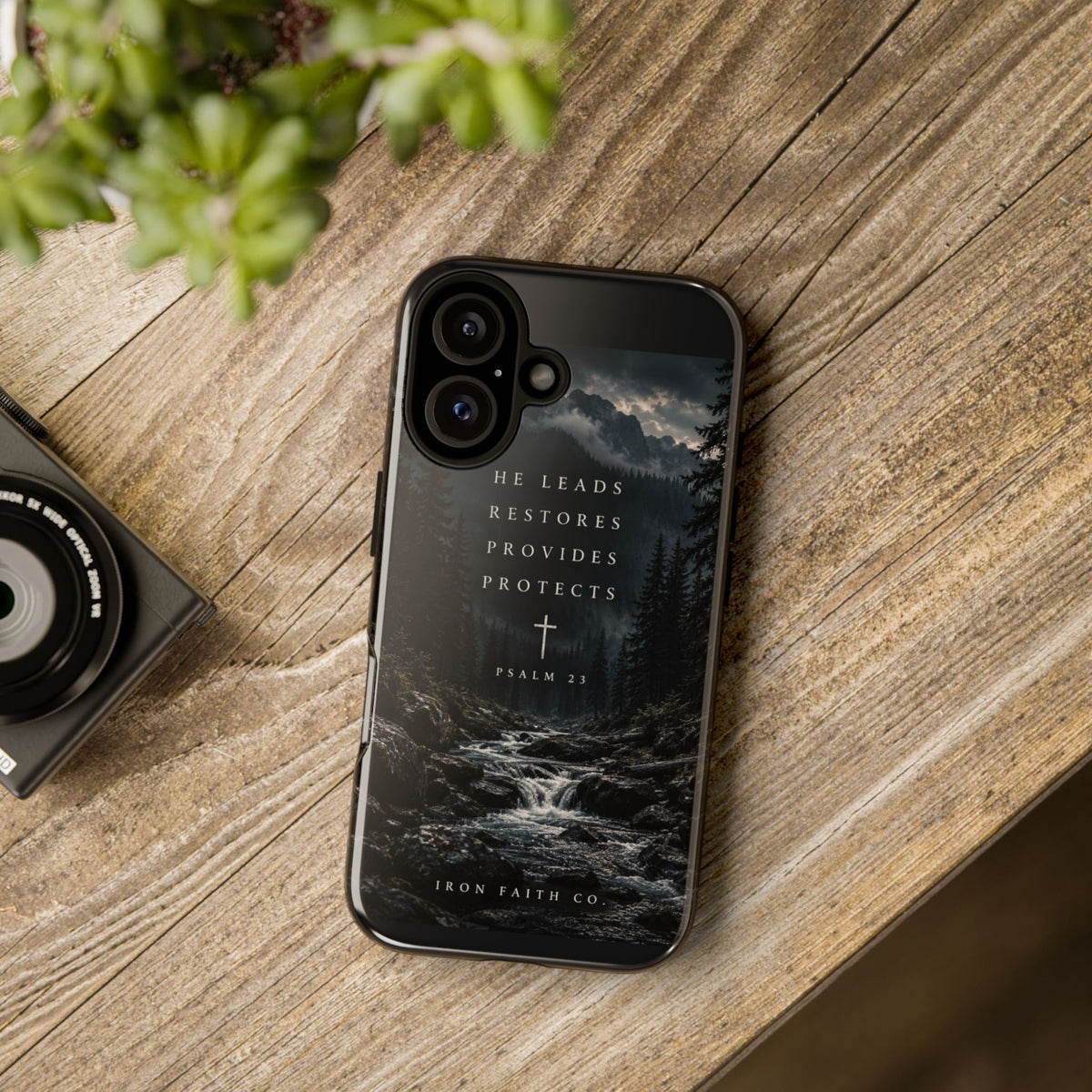 The He Leads Psalm 23 Phone Case shown in a styled everyday scene (product mockup)