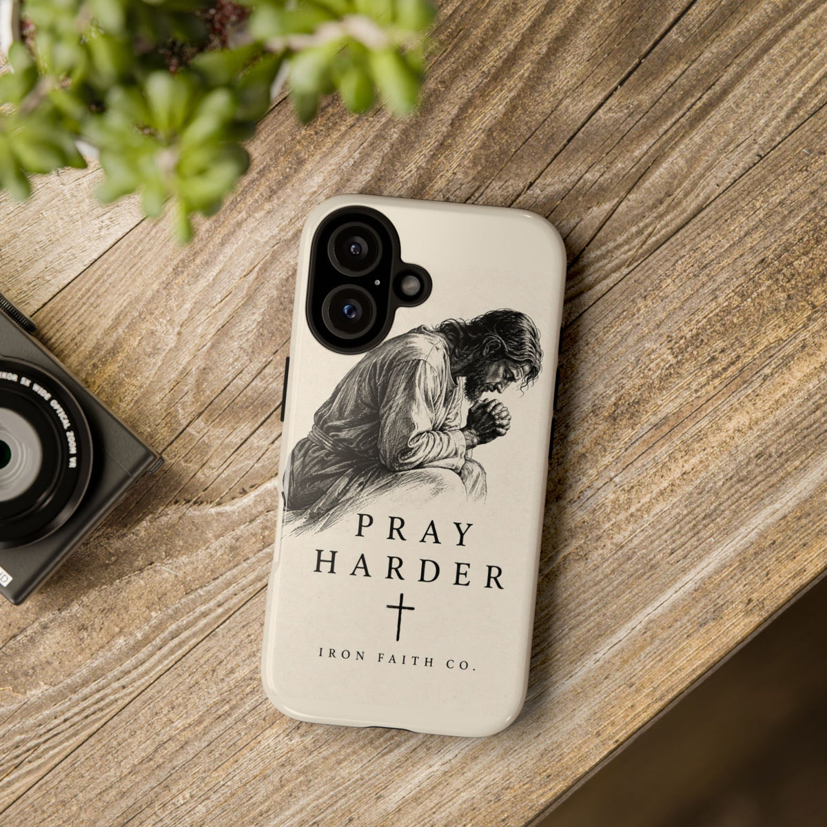 The Pray Harder Phone Case shown in a styled everyday scene (product mockup)