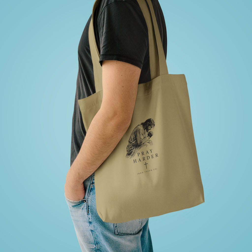 The Pray Harder Tote Bag shown in a styled everyday scene (product mockup)