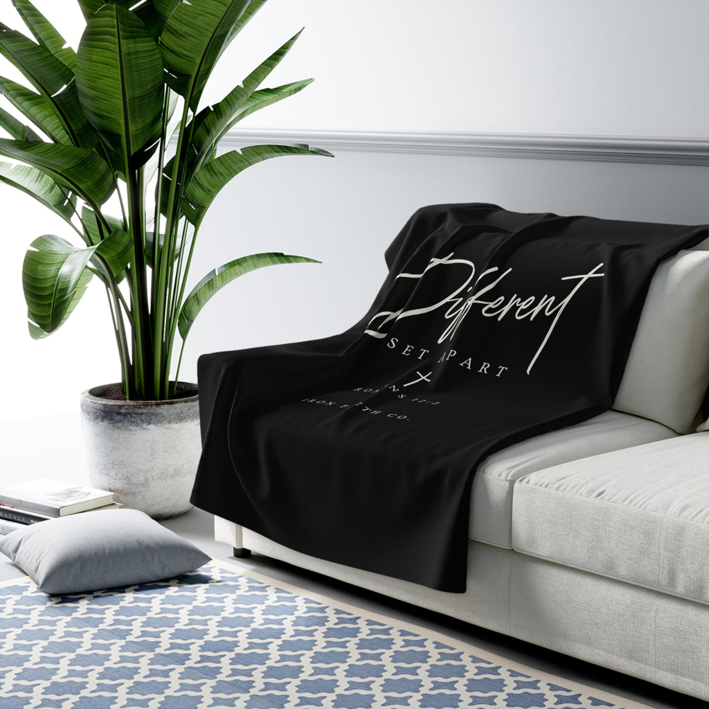 Different Romans 12:2 Sherpa Fleece Blanket draped over a gray sofa in a living room – product mockup