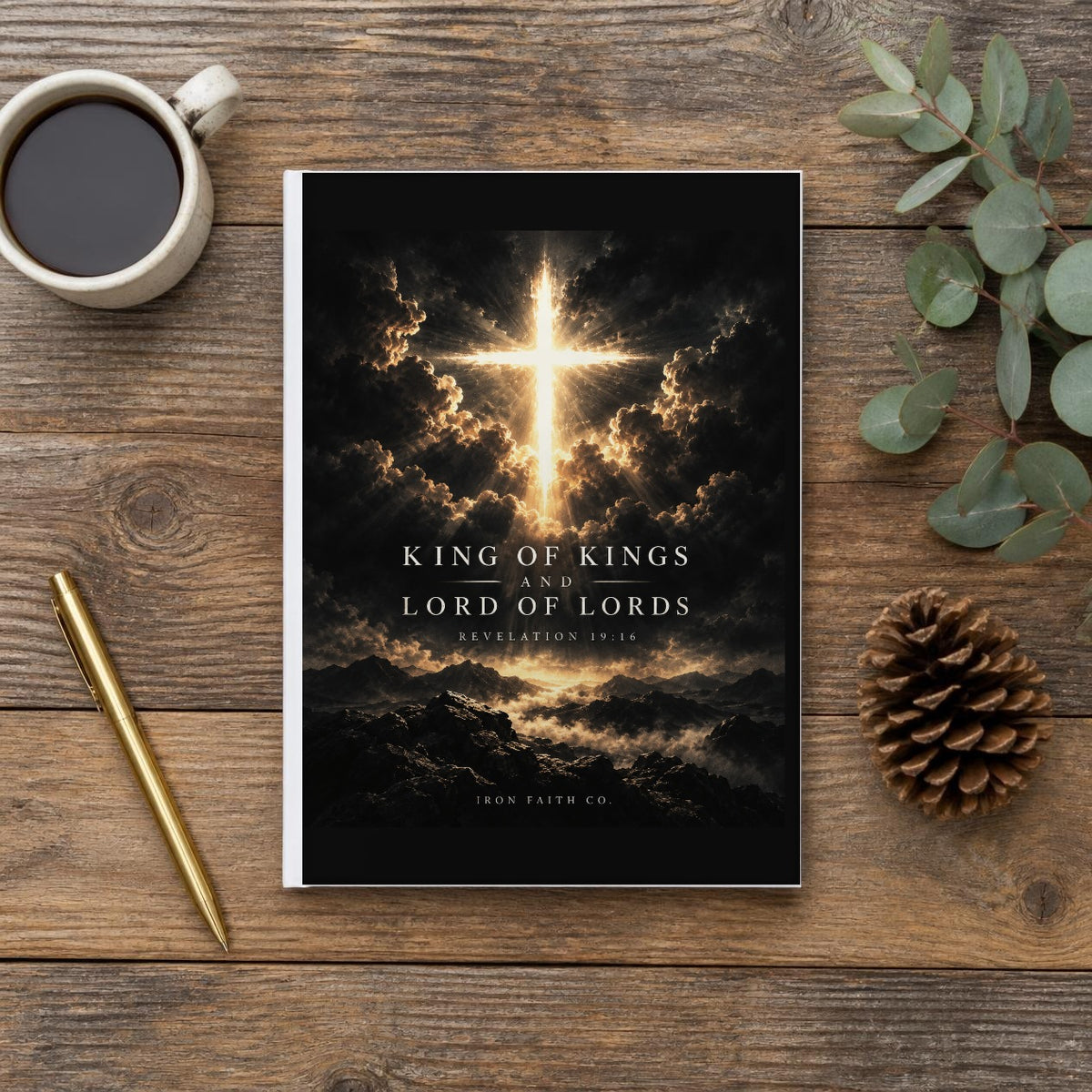 The King of Kings Revelation 19:16 Hardcover Journal on a wooden table with coffee, a pen and a pine cone (digitally composited scene image)