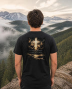 Fictional model wearing the King of Kings Revelation 19:16 Tee – Back Print in Black, back view, Pacific Northwest scene (digitally composited lifestyle image)