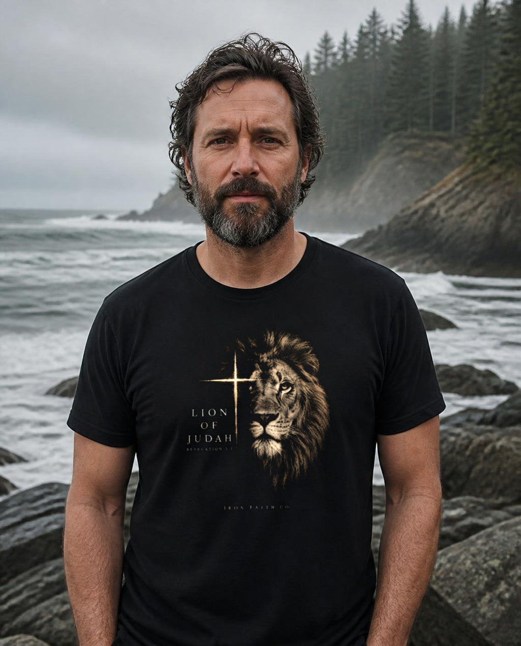 Lifestyle image (digitally composited, real print artwork at true print size): Lion of Judah tee on a fictional model on a rugged Pacific Northwest coastline