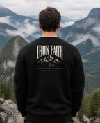 Fictional model wearing the Built on a Higher Standard Crewneck – Back Print in Black, back view, Pacific Northwest scene (digitally composited lifestyle image)