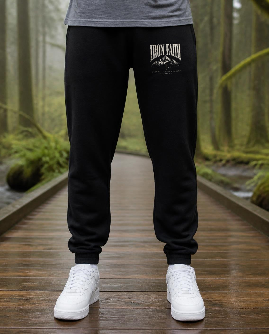Fictional model wearing the Built on a Higher Standard Sweatpants in Black, Pacific Northwest scene (digitally composited lifestyle image)