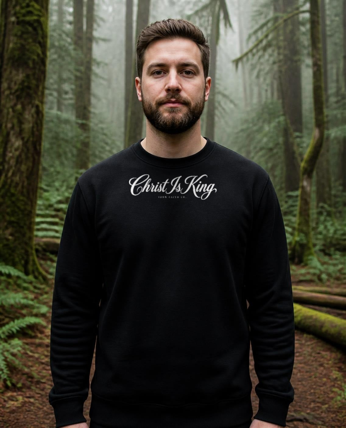 Fictional model wearing the Christ Is King Crewneck in Black, Pacific Northwest scene (digitally composited lifestyle image)