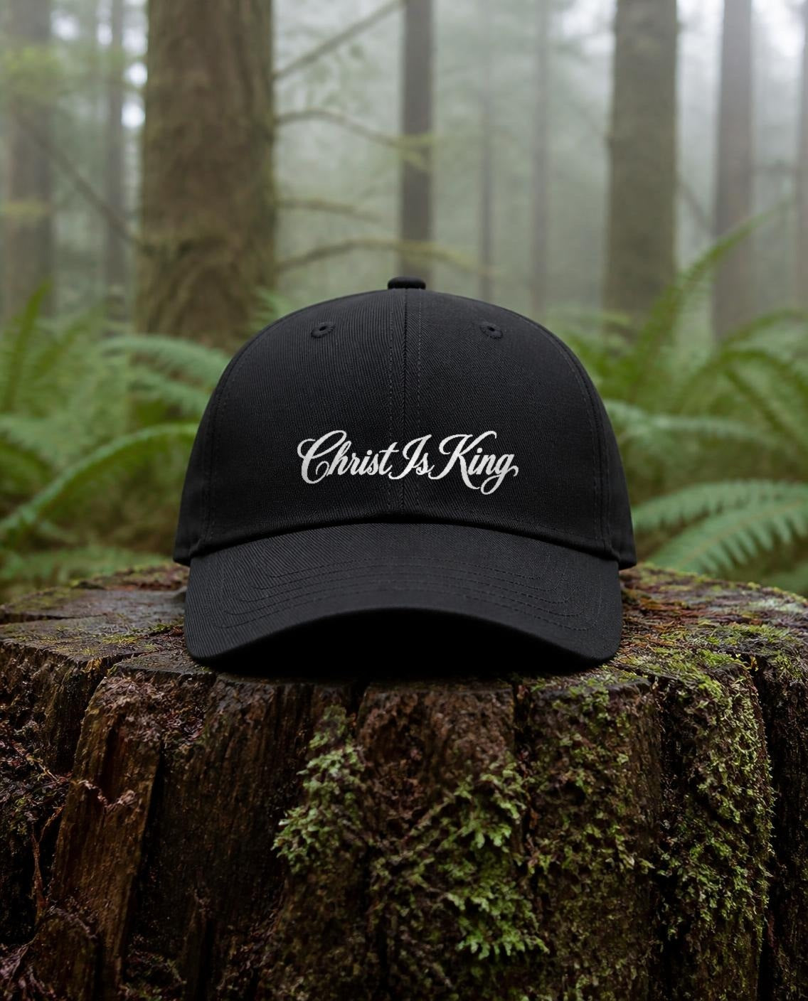 Christ Is King Dad Hat in Black shown outdoors (digitally composited lifestyle image)