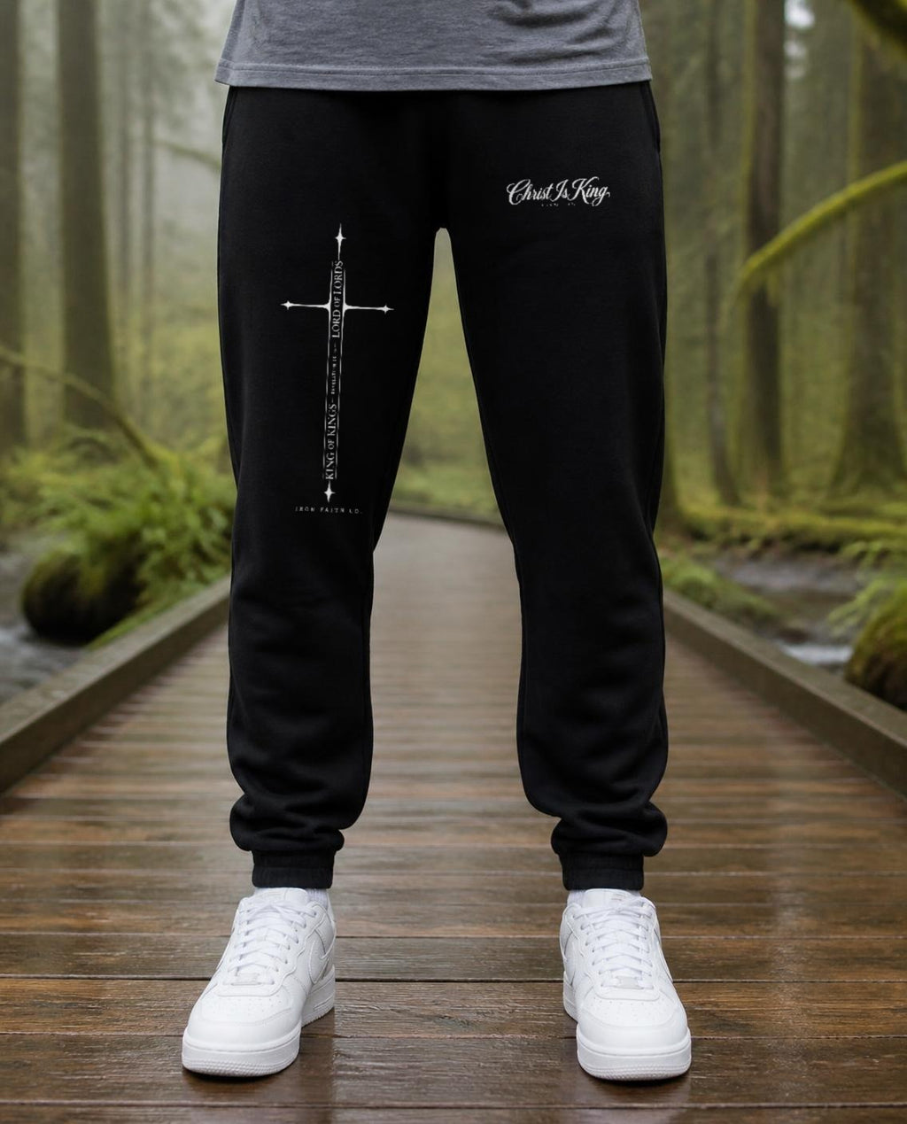 Fictional model wearing the Christ Is King Sweatpants in Black, Pacific Northwest scene (digitally composited lifestyle image)