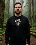 Fictional model wearing the Good Things Come From Obedience Crewneck in Black, Pacific Northwest scene (digitally composited lifestyle image)