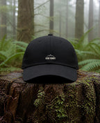 Good Things Come From Obedience Dad Hat in Black shown outdoors (digitally composited lifestyle image)