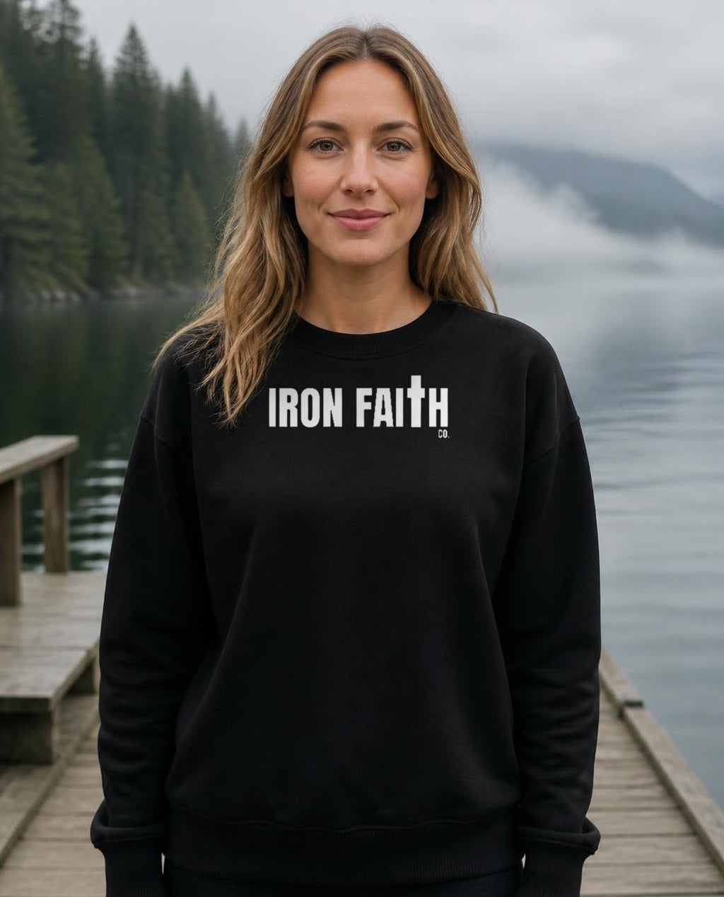 Fictional model wearing the Iron Faith Co. Wordmark Crewneck in Black, Pacific Northwest scene (digitally composited lifestyle image)
