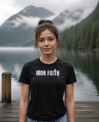 Fictional model wearing the Iron Faith Co. Wordmark Women's Fitted Tee in Black, Pacific Northwest scene (digitally composited lifestyle image)
