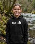 Fictional model wearing the Iron Faith Co. Wordmark Youth Hoodie in Black, Pacific Northwest scene (digitally composited lifestyle image)