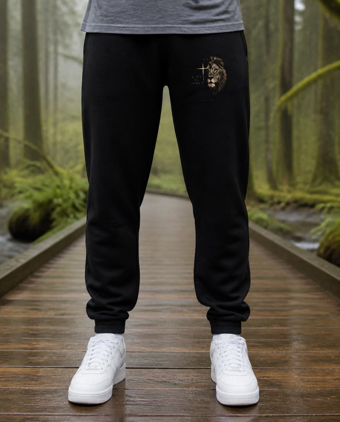 Fictional model wearing the Lion of Judah Sweatpants in Black, Pacific Northwest scene (digitally composited lifestyle image)