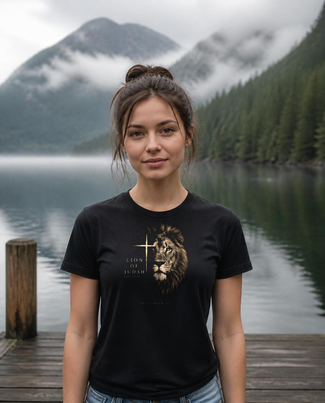 Fictional model wearing the Lion of Judah Women's Fitted Tee in Black, Pacific Northwest scene (digitally composited lifestyle image)