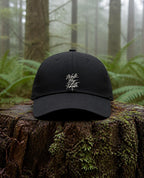 Walk By Faith Dad Hat in Black shown outdoors (digitally composited lifestyle image)