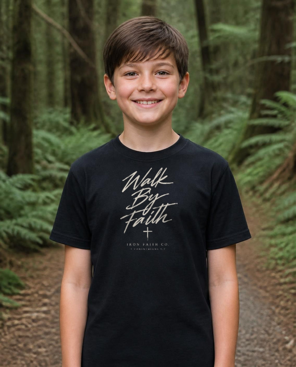 Fictional model wearing the Walk By Faith Youth Tee in Black, Pacific Northwest scene (digitally composited lifestyle image)