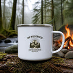 The Wilderness Enamel Camp Mug (white enamel) on a mossy log beside a campfire – digital mockup
